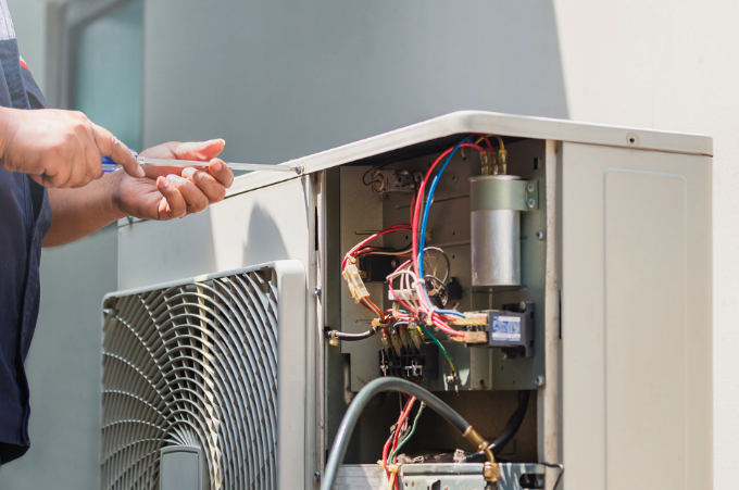 Opening up an HVAC panel to diagnose the problem
