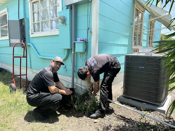 Our field team members fixing a customer's broken AC unit